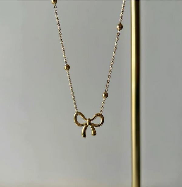 Golden Bow Luxe Pendant Necklace – Graceful Gold Charm with a Playful Ribbon Touch | Heer Glam Jewellery